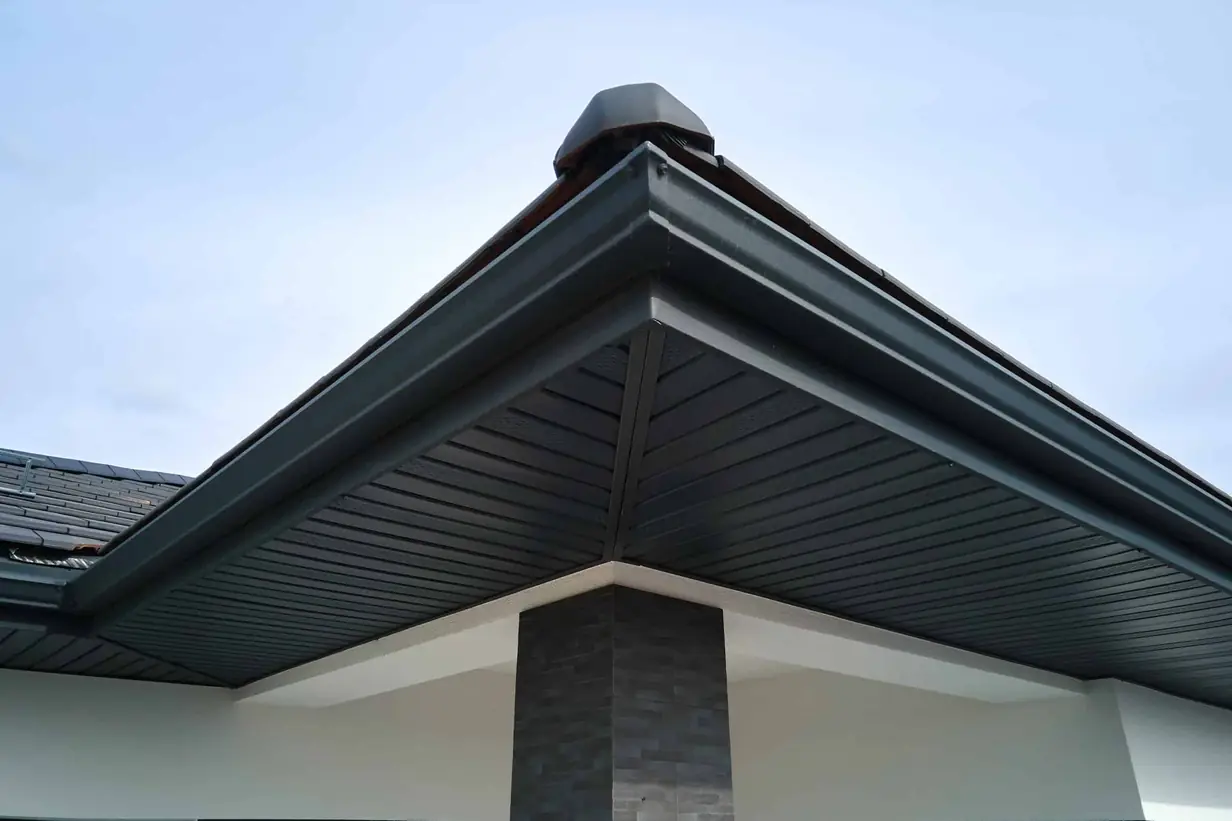 a close-up view of the corner of a modern house's roofing and drainage system