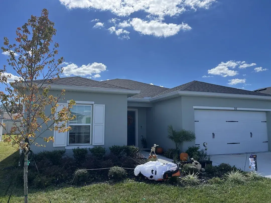 Gray home with white seamless gutters and a two-car garage