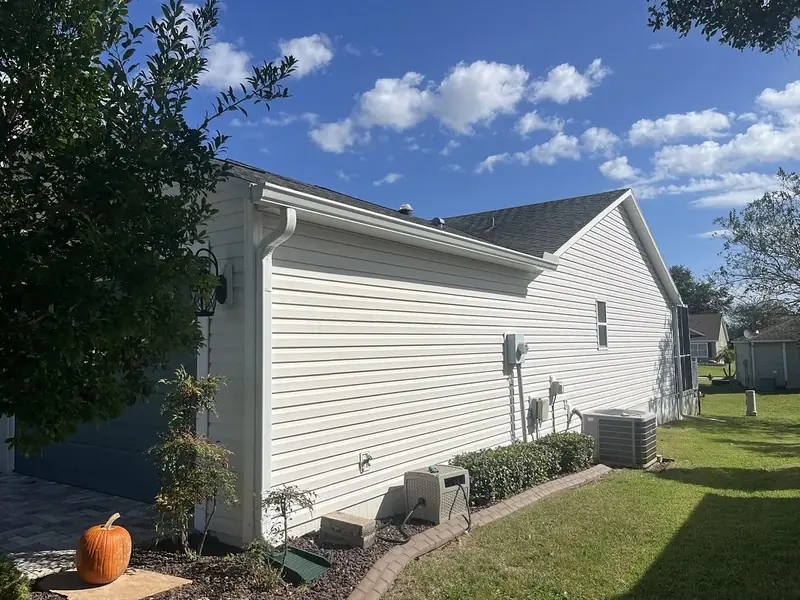 Home with white siding and white seamless gutters