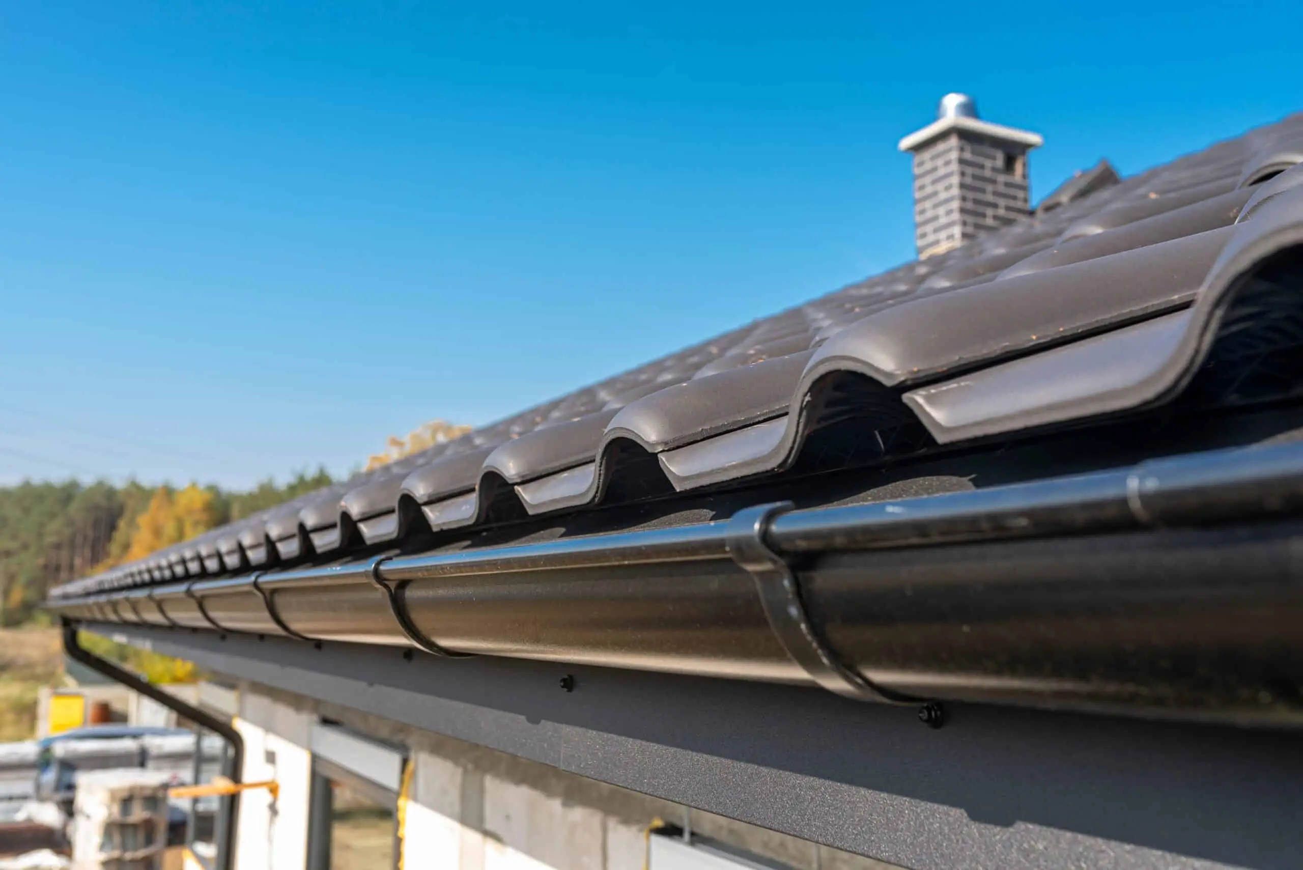 Black gutter along a dark tile roof